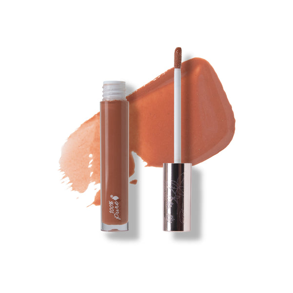 Lip gloss with applicator and swatch on a white background