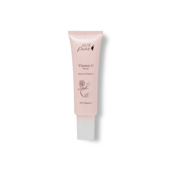 Pink skincare serum tube labeled '100% Pure Vitamin C Serum' on a white background