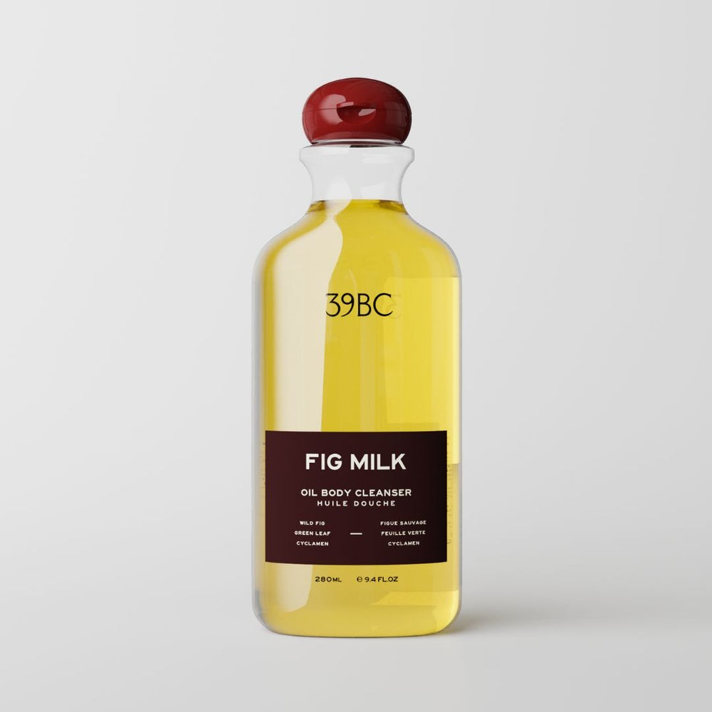 A 280ml bottle of 39BC Fig Milk Oil Body Cleanser, featuring a clear bottle filled with yellow oil, a dark brown label, and a glossy red cap, set against a plain white background.