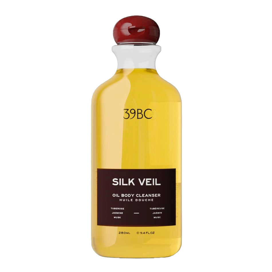A 280ml bottle of 39BC Silk Veil Oil Body Cleanser, filled with a golden yellow liquid and featuring a dark brown label with a glossy red stopper, set against a plain white background.