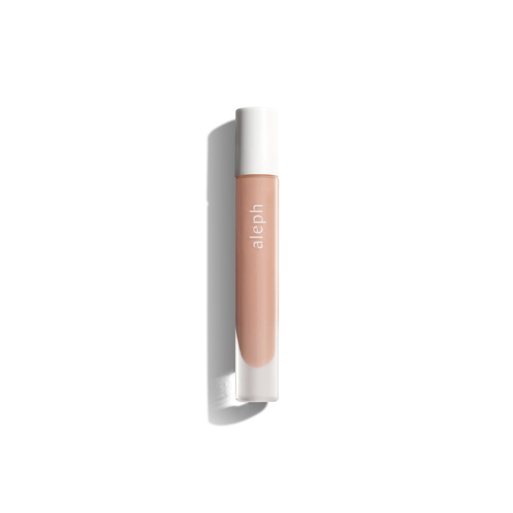 Aleph Lucid Lip Gloss/Balm – clear, glossy, and ultra-nourishing lip balm in a sleek vial.