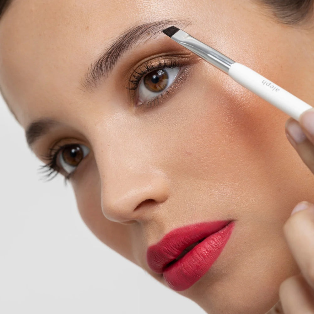 ALEPH Liner/Brow Brush with fine angle for precision and spoolie for brow grooming.