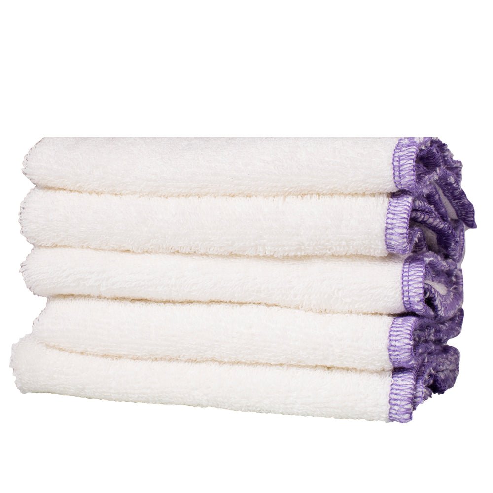 Living Libations Organic Hemp Face Cloths folded on a wooden surface. 1 cloth