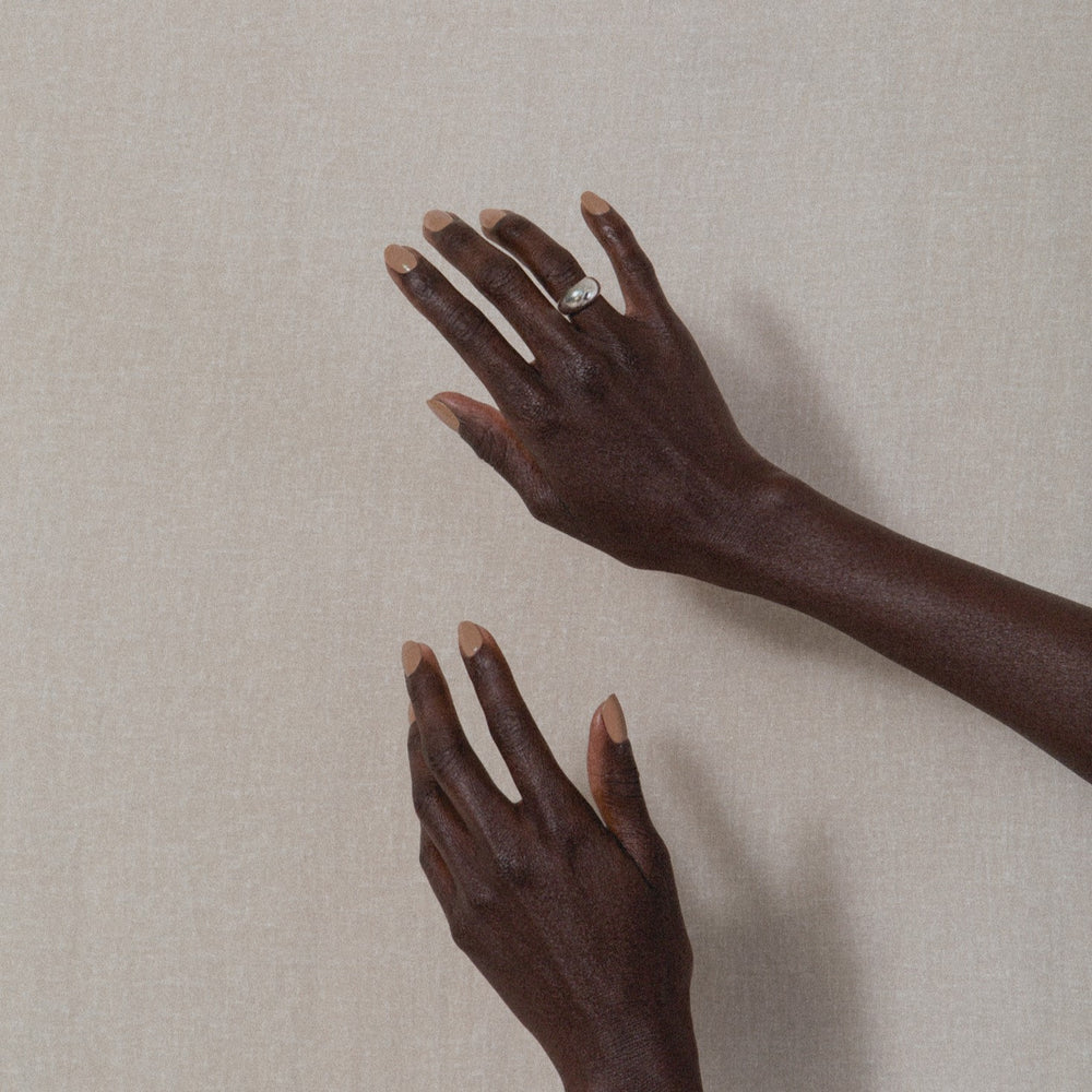 J. HANNAH Dune Nail Polish is a darker sandy beige color on white background