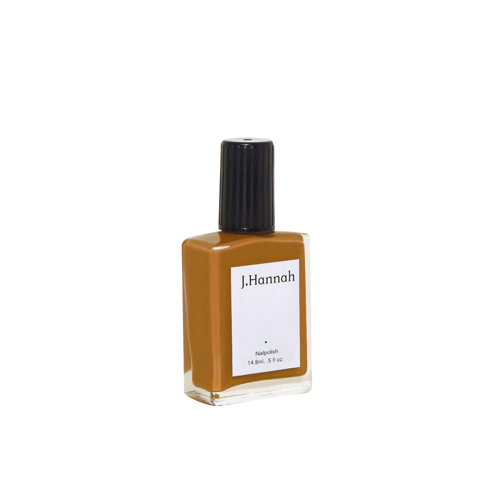 J. HANNAH Fauna Nail Polish is a dark browny orange, a dark curcuma color, on white background