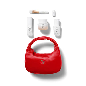 Red handbag with Agent Nateur skincare products on a white background