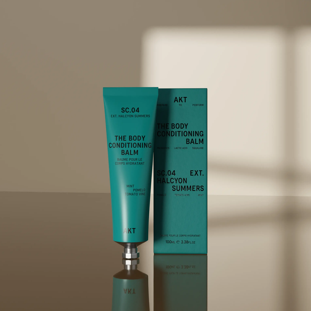 A teal tube of AKT London The Body Conditioning Balm, scent SC.04 Halycon Summers, on white background.