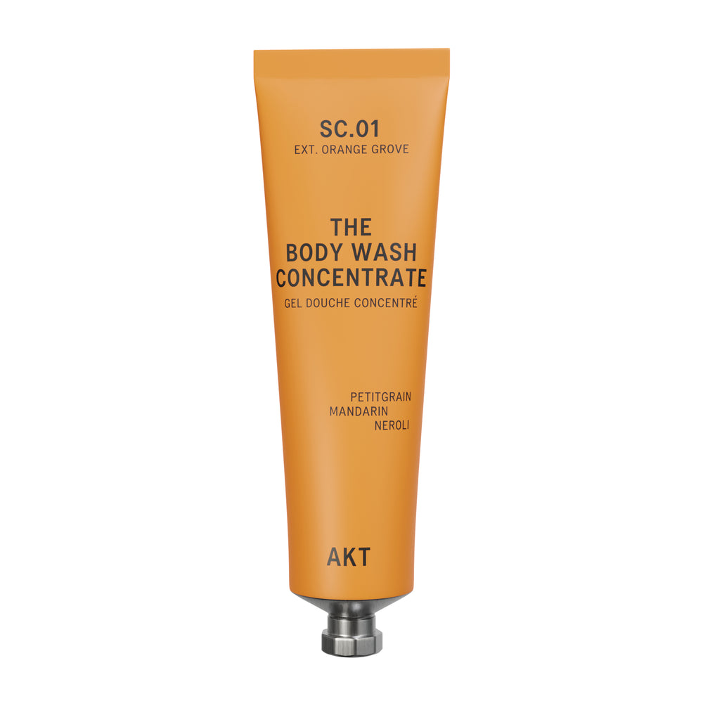 A squeeze tube of AKT London The Body Wash Concentrate in SC.01 Orange Grove on white background.