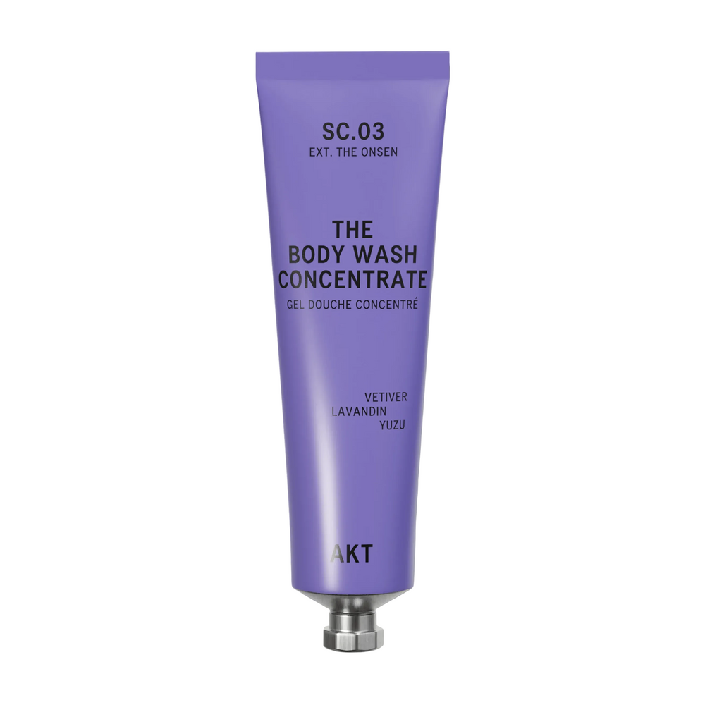 A lavender purple squeeze tube of AKT London The Body Wash Concentrate (SC.03) with a silver metal cap, centered on a clean off-white background.