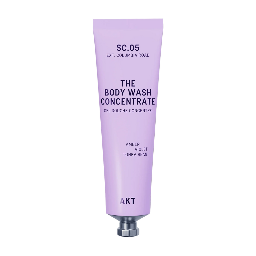 A lavender tube of AKT London The Body Wash Concentrate, SC.05, on a light off-white background with a soft shadow.