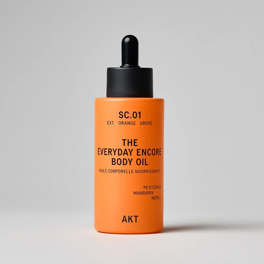 A bottle of AKT London The Everyday Encore Body Oil in the scent SC.01 Orange Grove.