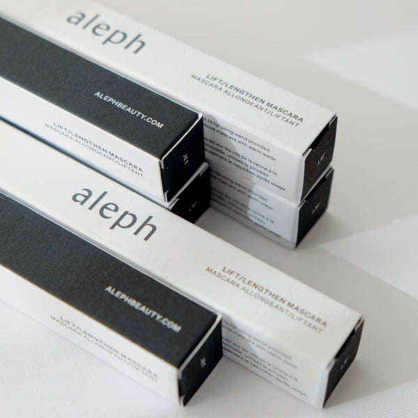 A few boxes of aleph mascara on a white background