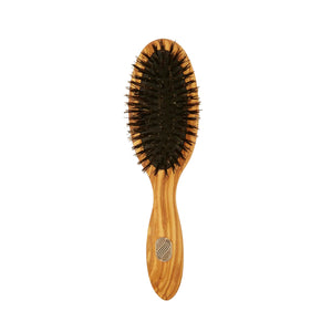 Wooden hairbrush with black bristles on a white background