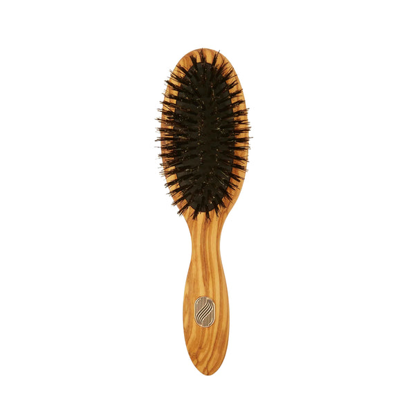 Wooden hairbrush with black bristles on a white background