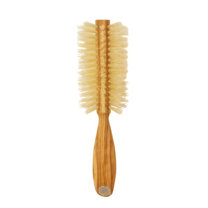 Wooden hairbrush with bristle head on a beige background