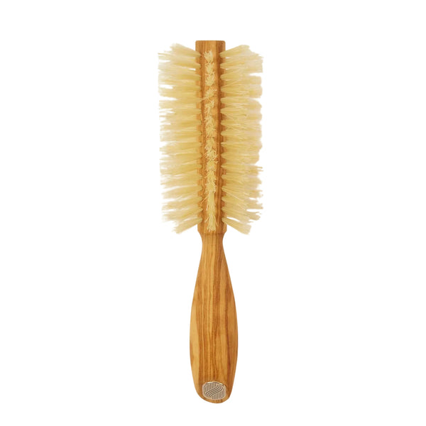 Wooden hairbrush with bristle head on a beige background