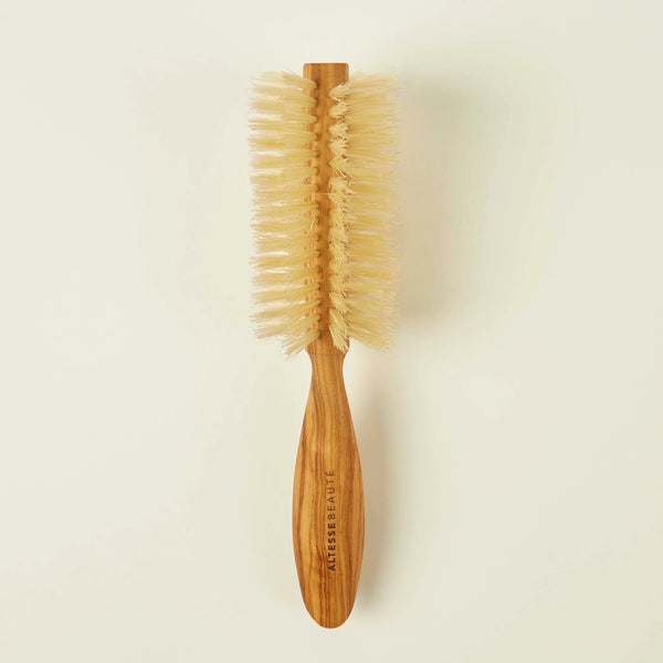 Wooden hairbrush with bristles on a beige background