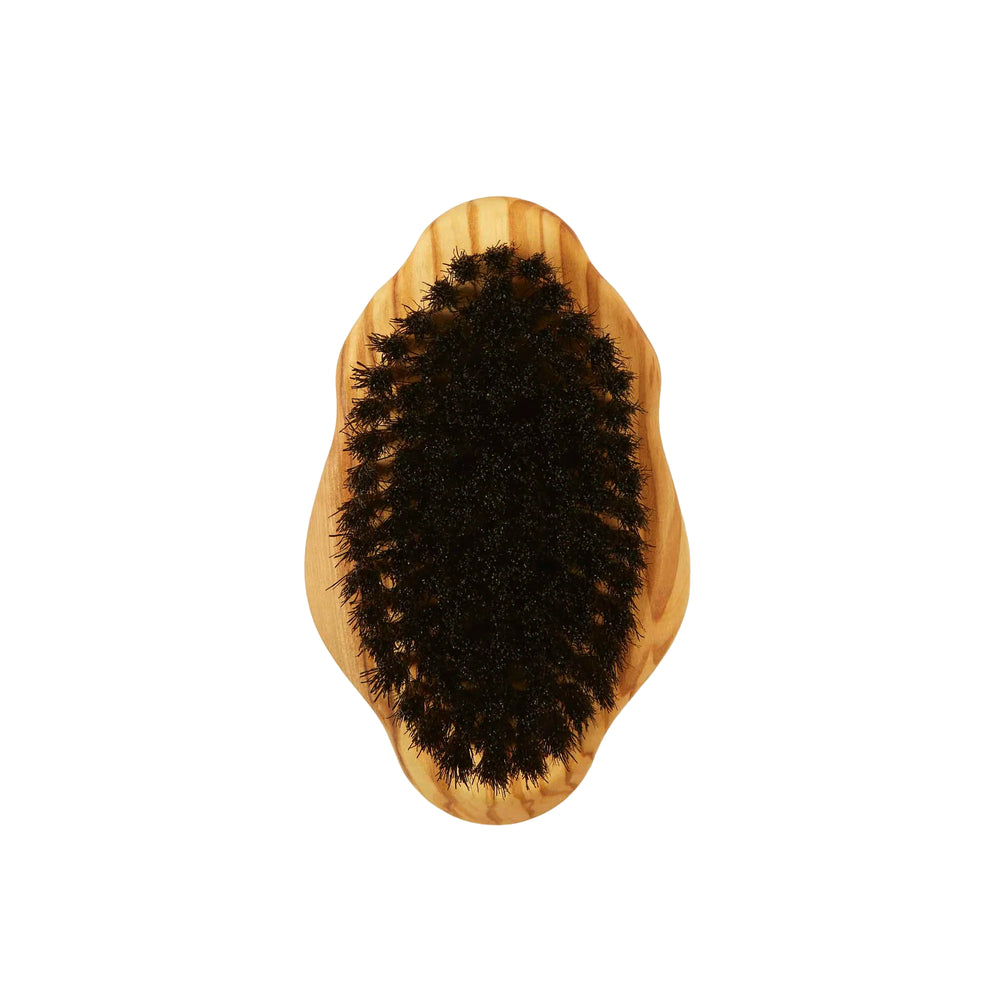 Wooden body brush with black bristles on a white background