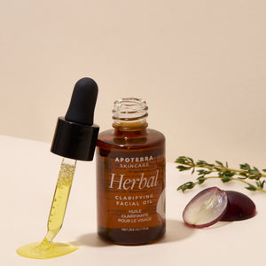 Apoterra Skincare Herbal Clarifying Facial Oil with dropper on a beige background