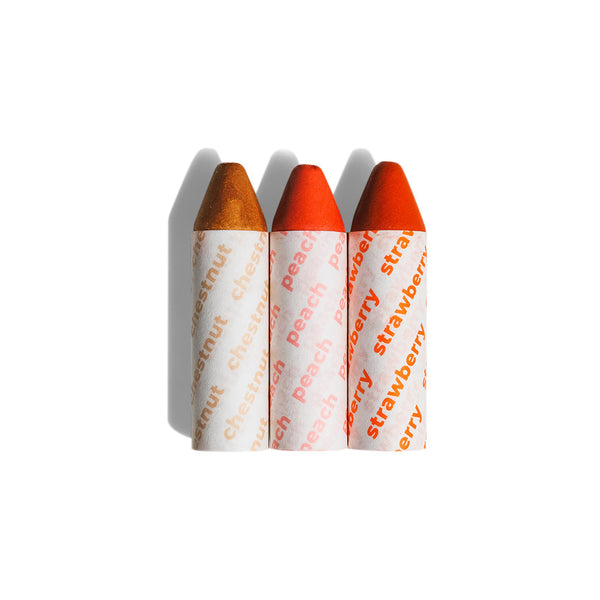 Axiology Balmie Trio Set in Golden Hour, including Chestnut, Peach, and Strawberry shades, matte multi-use crayons for eyes, lips, and cheeks, vegan and eco-friendly.