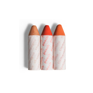 Axiology Balmie Trio Set in Malibu Magic, featuring Champagne, Peach, and Clementine shades, matte multi-use crayons for eyes, lips, and cheeks, vegan and eco-friendly.