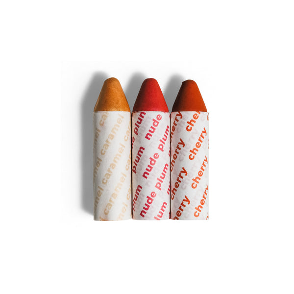 Axiology Balmie Trio Set in Of the Earth, featuring Caramel, Nude Plum, and Cherry shades, matte multi-use crayons for eyes, lips, and cheeks, vegan and eco-friendly.