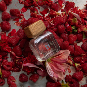 Perfume bottle AYOND Flower Eater Eau De Parfum with wooden cap on raspberries and flowers