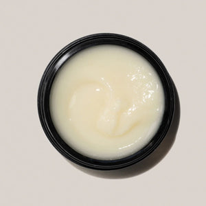 An open black jar of cleansing balm in beige color, this is AYOND Metamorph Cleansing Balm