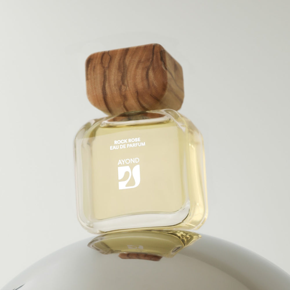 Perfume bottle with wooden cap from Ayond on a white background