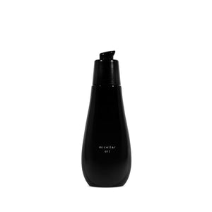 Ayuna Micellar Oil in black glass bottle with black pump on a white background