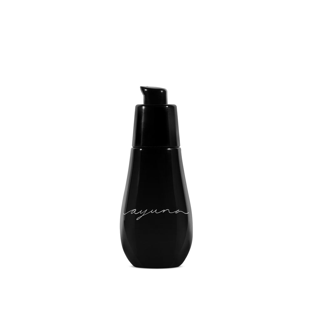 AYUNA need-le serum in glass black bottle with black pump on white background.