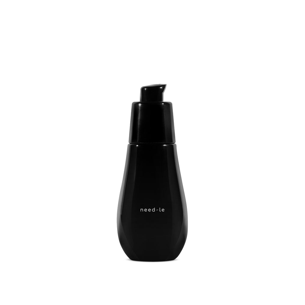 AYUNA need-le serum in glass black bottle with black pump on white background.