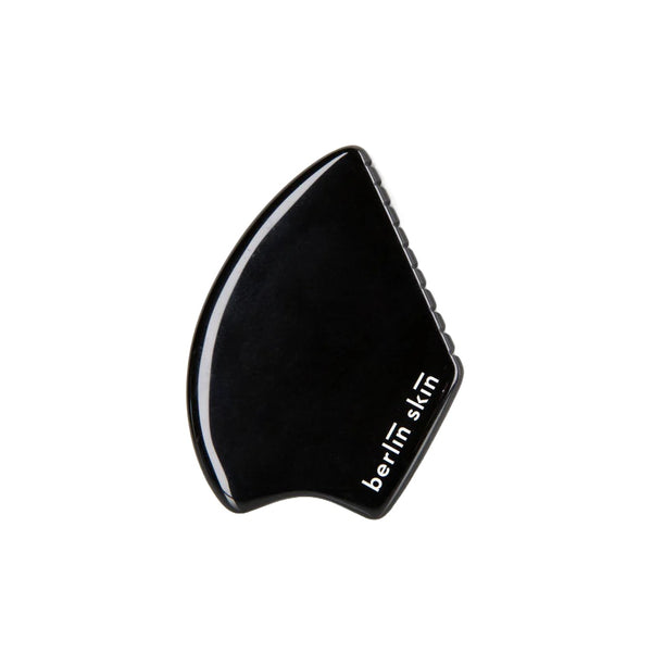 BERLIN SKIN Gua Sha Tool made from black obsidian for a soothing self-care ritual, offering gentle, effective strokes to refresh and smooth the skin.