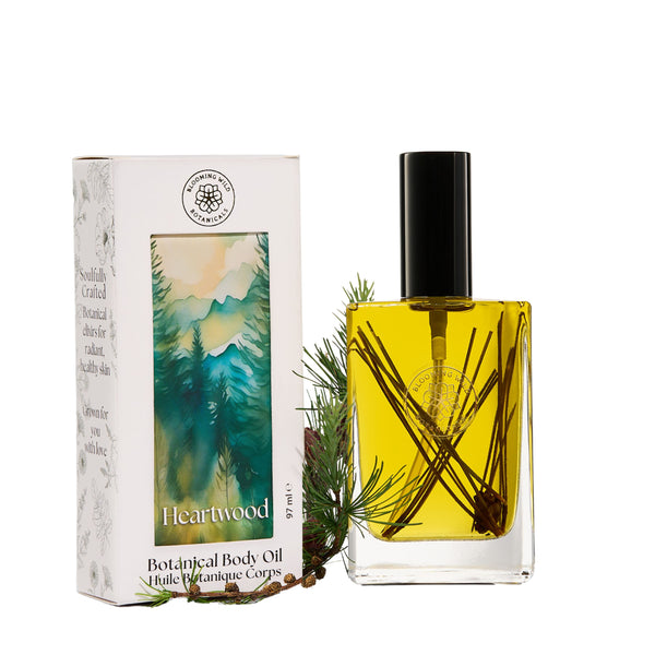 Blooming Wild Heartwood Body Oil in a glass bottle, infused with red pine, balsam fir, and cedar for deeply grounding skin nourishment.