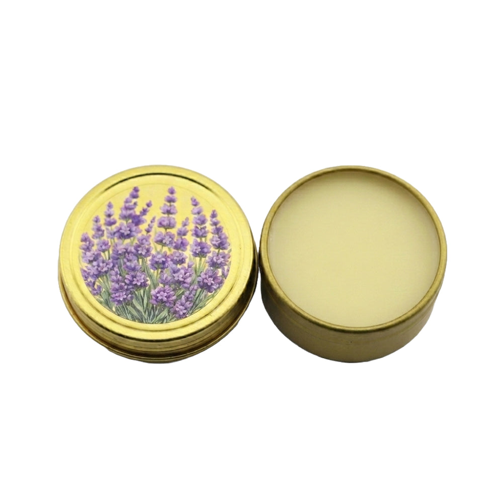 An open round metal tin with a gold-colored lid featuring an illustration of purple lavender flowers, next to the open base showing a pale cream-colored balm inside, on a white background.