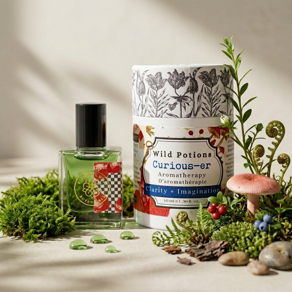 Bottle and packaging of Wild Potions Curious-er aromatherapy product on a white background