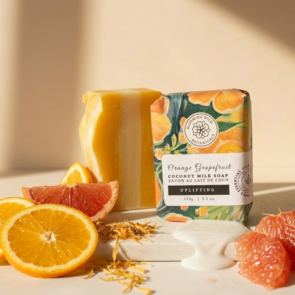 Bar of soap with packaging featuring orange and grapefruit design on a white background