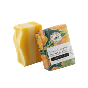 Bar of soap with packaging featuring orange and grapefruit design on a white background
