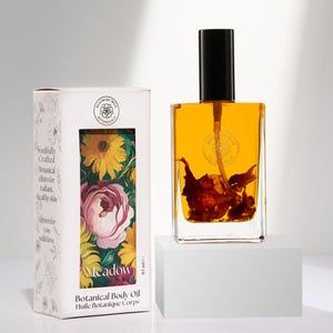 Botanical body oil bottle and packaging with floral design on a white background. BLOOMING WILD Meadow Botanical Body Oil