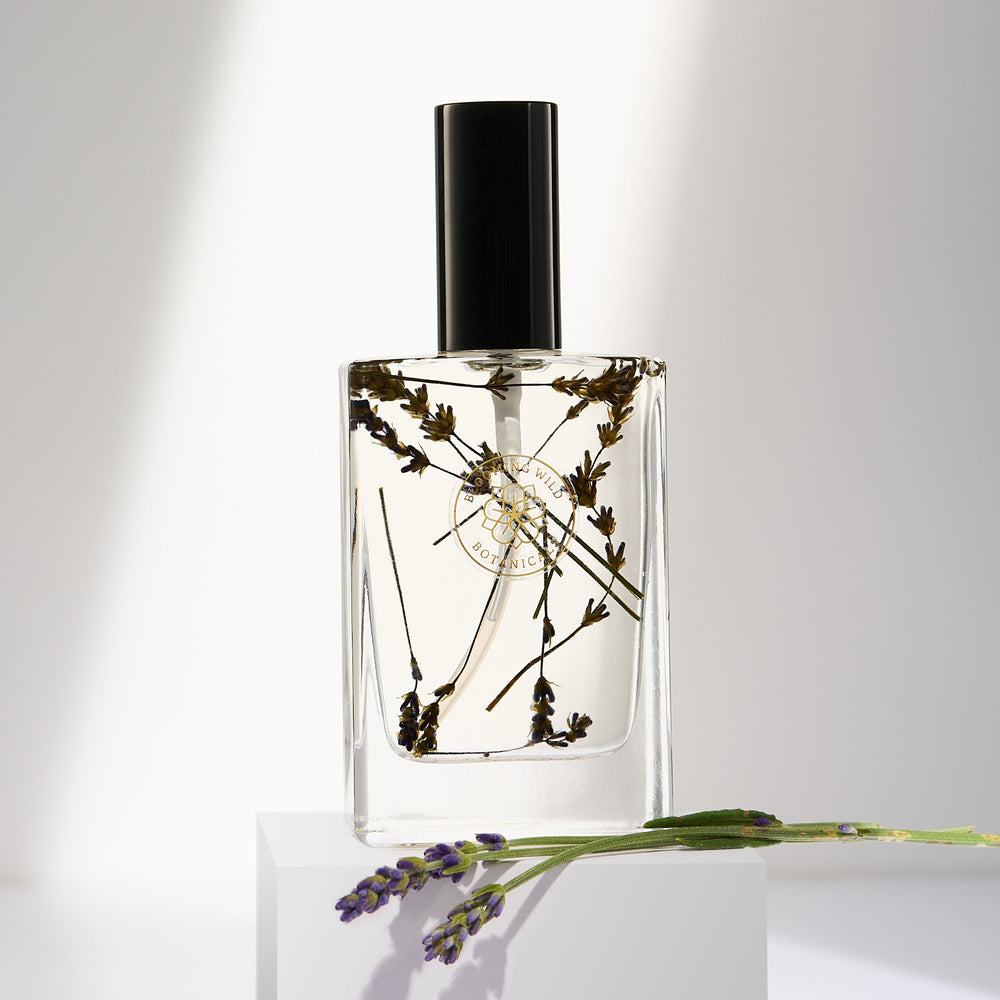 Blooming Wild Summer Nights Lavender Body Oil in a glass bottle, infused with farm-grown lavender for calming, soothing skin care.