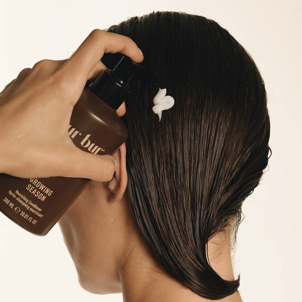 Brown bottle with black pump of BUR BUR Growing Season Nourishing Conditioner on a white background