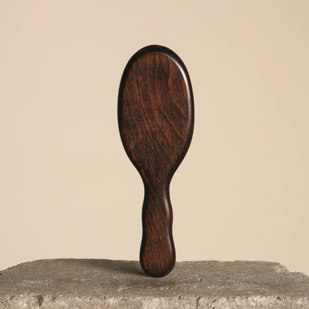 Wooden hairbrush with black bristles from Bur Bur on a white background