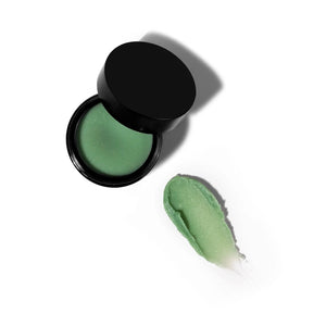 By Achilles Beauty Balm in jar, showcasing its rich, green, botanical formula designed to hydrate and nourish the skin.