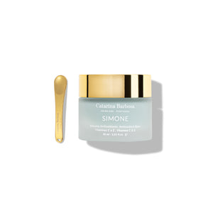 Catarina Barbosa Simone antioxidant balm with a blue-hued color in a jar with gold cap on white background.