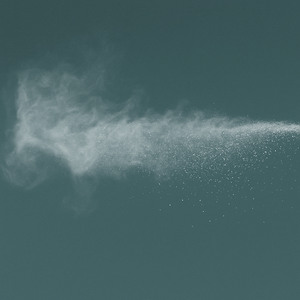 White powder being sprayed against a dark background