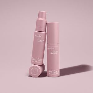 Two pink bottles of 'Cleo & Coco' powder on a light pink background