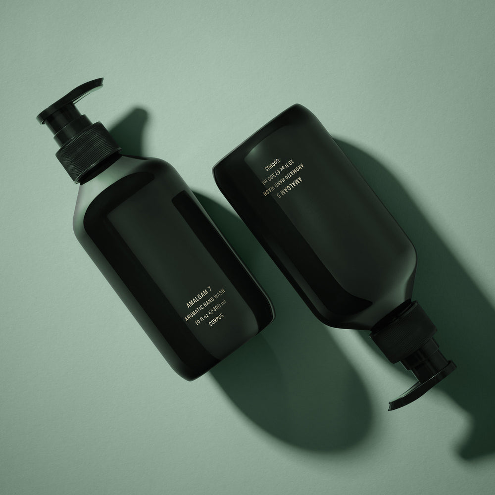 CORPUS Aromatic Hand Wash Amalgam 5 in a sleek recycled plastic bottle with FSC-certified packaging, scented with lemon, bergamot, vetiver, cypress, and cedar.