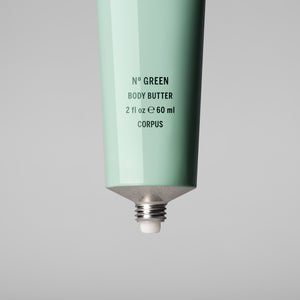 Mint green body butter tube with text on a gray background. CORPUS Body Butter Nº Green Mini