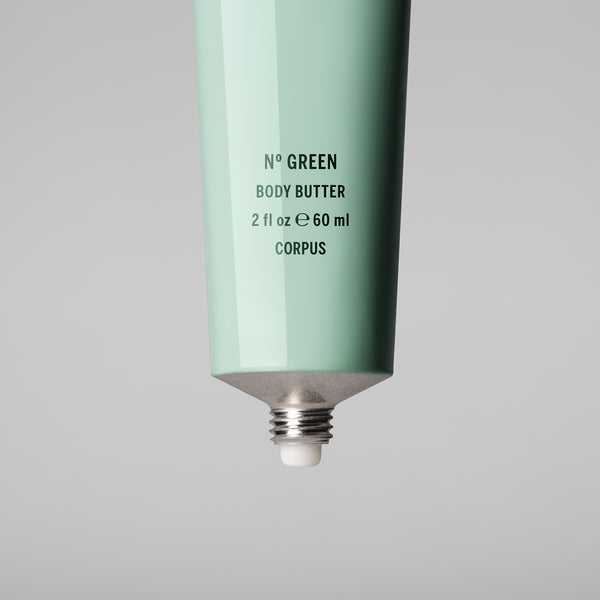 Mint green body butter tube with text on a gray background. CORPUS Body Butter Nº Green Mini