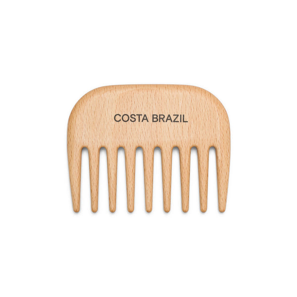 Wooden comb with 'Costa Brazil' branding on a white background